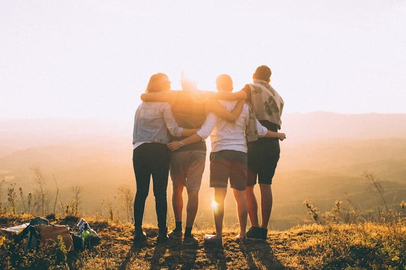 Group of people gathered together at a sunny California beach